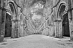 San Galgano abbey in Chiusdino, Siena, Tuscany, Italy. Roofless nave with colonnade of the medieval Gothic style church