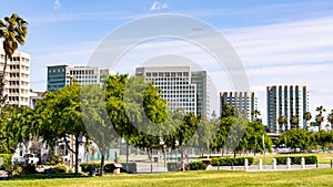 San Jose`s downtown skyline as seen from the shoreline of Guadalupe River Park on a sunny spring day; Silicon Valley, California