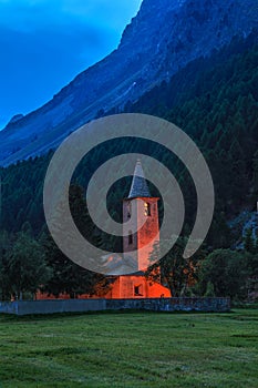 San Lurench church in Sils im Engadin village with illumination during blue hour.
