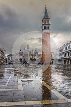 San Marco square under the rain with Bell Tower and Saint Mark& x27;s Basilica. The main square of the old town. Venice, Italy.
