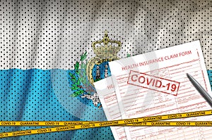 San Marino flag and Health insurance claim form with covid-19 stamp. Coronavirus or 2019-nCov virus concept