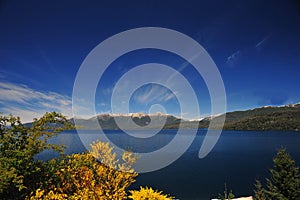 San Martin de los Andes, lake and transparent waters, white sand beaches with trees and blue sky, Neuquen, patagonia