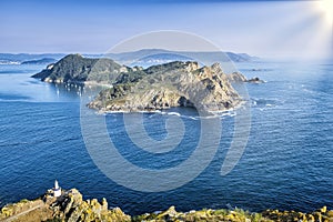 San MartiÃÂ±o Island seen from the top of Montefaro in the Cies Islands, Galicia, with a blue Atlantic Ocean and a sky with the sun photo