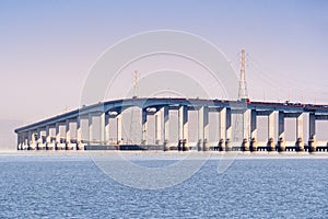 San Mateo Bridge connecting the Peninsula and East Bay in San Francisco Bay Area, California; Electricity towers and power lines