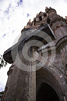 Cross outside the Parish of San Miguel ArcÃÂ¡ngel in San Miguel de Allende, Guanajuato, Mexico photo