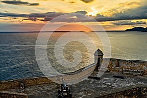 San Pedro de La Roca old Spanish fort walls with cannons, Carribean sea sunset view, Santiago De Cuba, Cuba