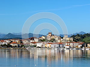 San Vicente de la Barquera reflected in water, coastal village in Cantabria, Nothern Spain