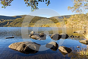 Sanabria Lake Natural Park in autumn at sunset with the mountains reflected in the water, Zamora, Castilla y LeÃ³n, Spain