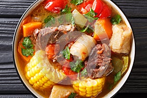 Sancocho Recipe a hearty and absolutely delicious stew made with meat, vegetables and spice close-up on a plate. horizontal top photo