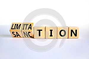 Sanction and limitation symbol. Turned wooden cubes and changed the word limitation to sanction. Beautiful white table, white photo