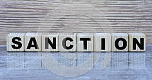 SANCTION - word on wooden cubes on a gray background