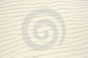 Sand as background texture. Wavy pattern of the wind