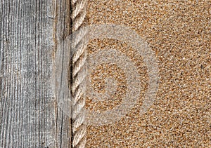 Sand background with old wood and rope