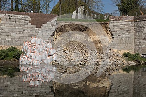 Sand bags preventing new collisions of a city wall