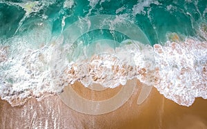 Sand beach aerial, top view of a beautiful sandy beach aerial shot with the blue waves rolling into the shore