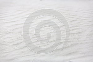 Sand on the the beach as background. Exotic tropical closeup of white sand pattern, beach template