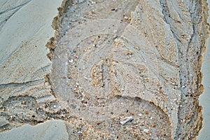 Sand on the beach background traces left on the sand after the tide