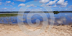 Sand beach and blue summer sky at Biscarrosse lake in landes France photo