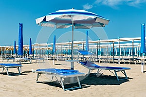 Sand beach with chaise longue and umbrellas Riccione, rimini, it