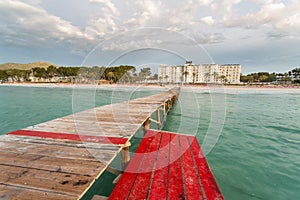 Sand beach deck chairs and pontoon