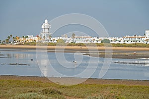 sand beach at Isla Cristina at the Costa de la Luz in Andalusia with view to town and lighthouse photo