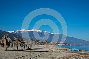 Sand beach in Nei Pori village with Olympus mountain at background. Sunny winter day. Pieria, Greece. photo
