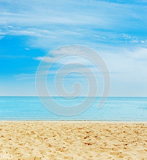 sand on the beach. sea on horizon and blue sky with clouds photo