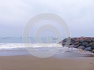 Sand beach, stone, ocean, clouds