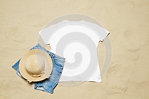 Sand beach texture background. Mockup white summer t-shirt outfit copy space. Blank template woman shirt Top view. Summertime