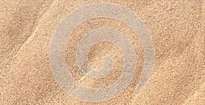 Sand Beach Texture Background in Summer, Top view Brown Sandy Rough Surface with Wave Ripple of Sea Water with copy space for