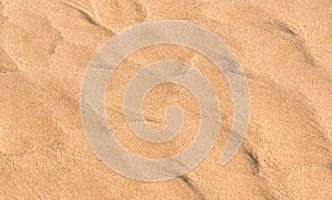 Sand Beach Texture Background in Summer, Top view Brown Sandy Rough Surface with Wave Ripple of Sea Water with copy space for