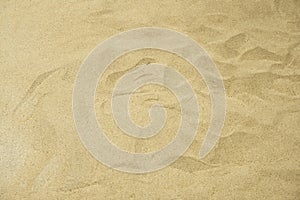 Sand on The Beach Texture in the Summer Sun Day. Nature Beautiful Brown Lines in the Golden Sandy. Top View of Empty Tropical Sand