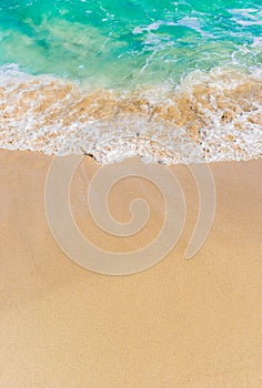 Sand beach and tropical sea water on a sunny summer day