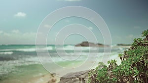 Sand beach and turquoise carribean sea on blue sky background.