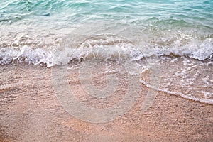 Sand beach with white sea soft wave on top view