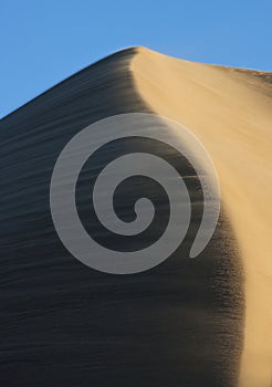 Sand blowing over a sand dune crest - Namibia