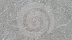 Sand bubbler crabs leaving sand bubblers on the sea wave beach in Hua Hin, Thailand.