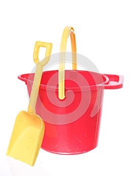 Sand bucket and shovel on white ground