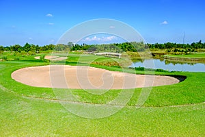 Sand bunker green golf field and blue cloud sky for backdrop background use