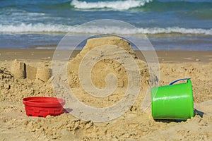 Sand castle and buckets on beach