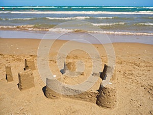 Sand castle or sandcastle on the beach at sea