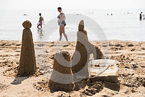 Sand castle on the sandy beach - beach holiday