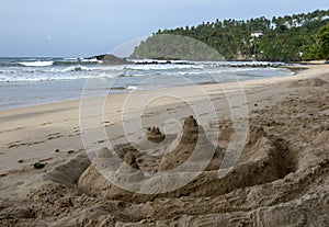 A sand castle sits on the beach at Mirissa in Sri Lanka.