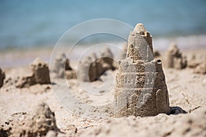 Sand castle standing on the beach. Travel vacations concept.