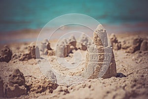 Sand castle standing on the beach. Travel vacations concept.