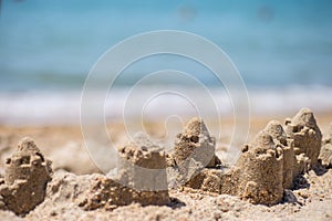 Sand castle standing on the beach. Travel vacations concept.