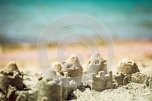 Sand castle standing on the beach. Travel vacations concept.