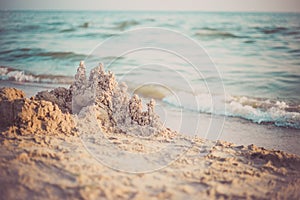 Sand castle standing on the beach. Travel vacations concept.