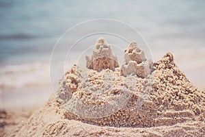 Sand castle standing on the beach. Travel vacations concept.