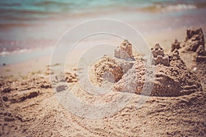 Sand castle standing on the beach. Travel vacations concept.